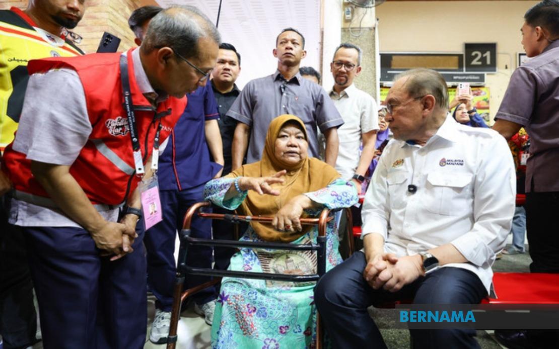 Against the odds: Disabled pensioner rides three-wheeler through rain to meet PM Anwar