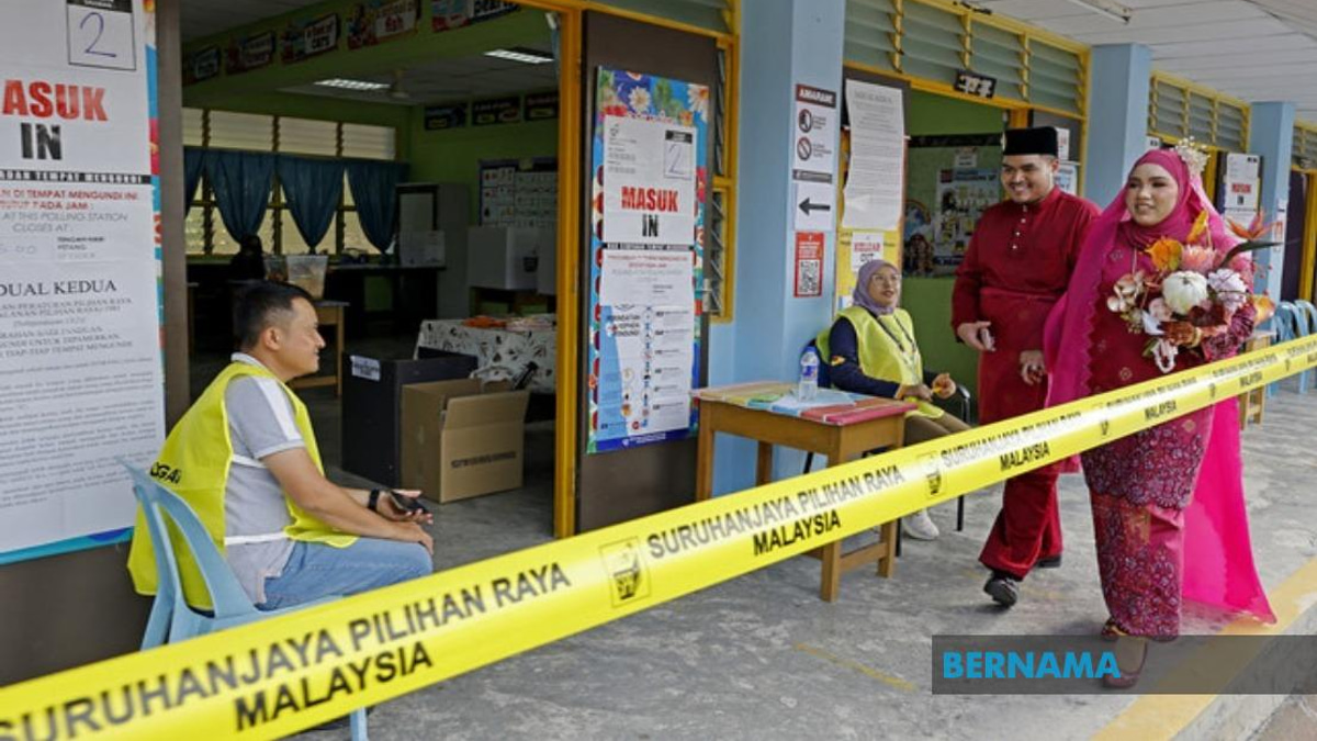 Young Bride Casts Vote in Wedding Gown at Negeri Sembilan Elections